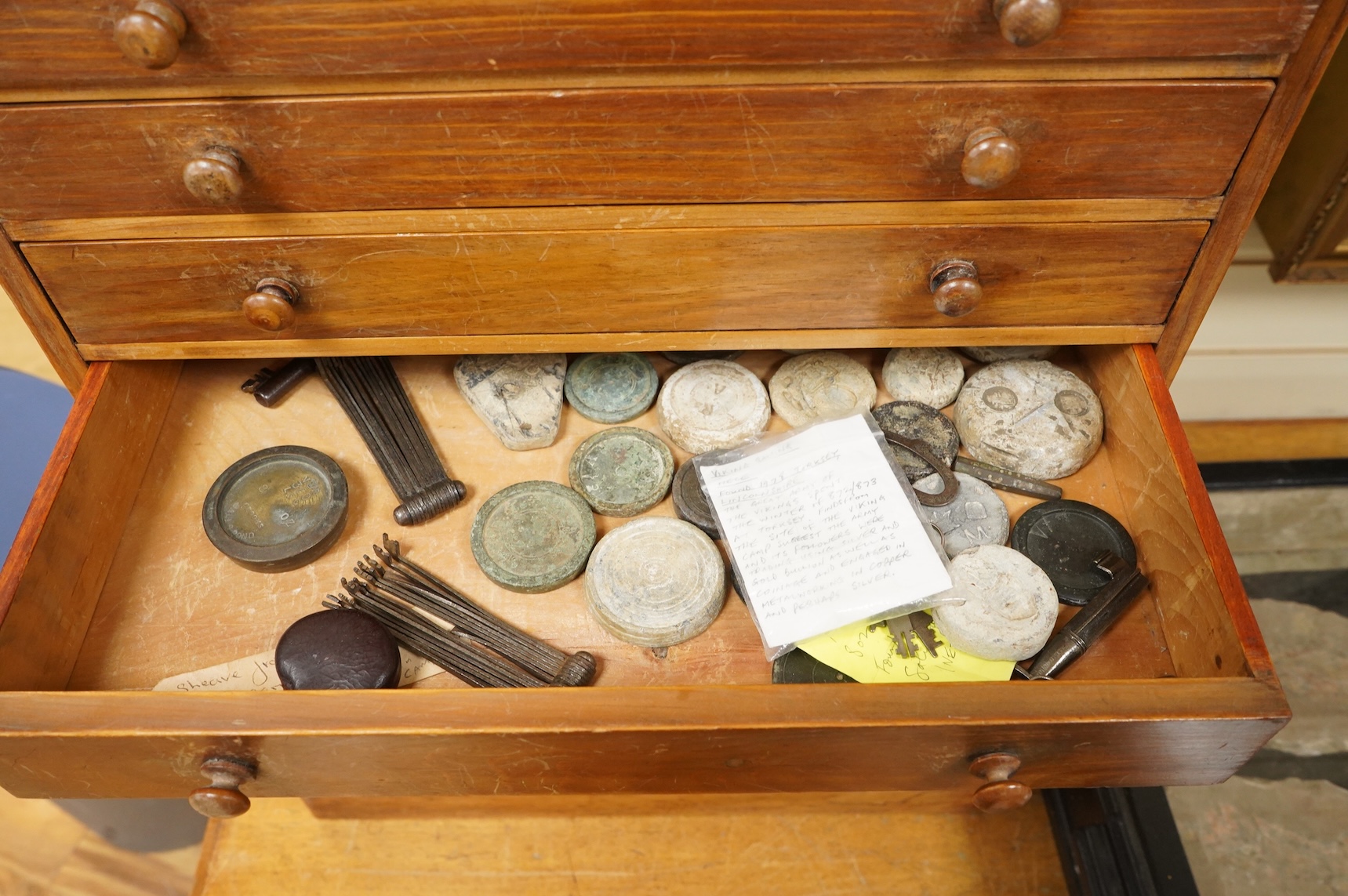 A collection of mainly 16th century to 19th century bronze and lead imperial circular trade weights stamped with Royal Cyphers, weights, the dagger assay mark for London, the ewer mark, other proof marks, etc., together